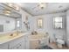 A bright bathroom featuring a soaking tub, vanity with sink, and coastal-themed decor at 4344 Ozark Ave, North Port, FL 34287