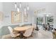 Dining room featuring a round table, stylish lighting, and easy access to a charming Florida room at 4344 Ozark Ave, North Port, FL 34287