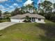 Beautifully landscaped single-story home with a spacious front yard and attached garage at 4344 Ozark Ave, North Port, FL 34287