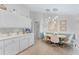 Modern kitchen with views of the dining room, pendant lights, and white cabinetry at 4344 Ozark Ave, North Port, FL 34287