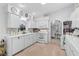 Bright, white kitchen featuring ample counter space, modern appliances, and open layout to the dining area at 4344 Ozark Ave, North Port, FL 34287