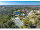 Scenic aerial view of the community featuring a pool, tennis court, and lush greenery at 446 Pendleton Ct, Venice, FL 34292