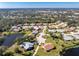 Scenic aerial view of a suburban neighborhood with water views and lush landscaping at 446 Pendleton Ct, Venice, FL 34292