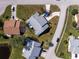 An aerial view of the property showcasing its landscaping, driveway and proximity to neighboring homes at 446 Pendleton Ct, Venice, FL 34292