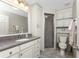 This bathroom features a granite vanity, built in cabinets, and a glass shower stall at 446 Pendleton Ct, Venice, FL 34292