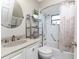 Cozy bathroom featuring a combined tub and shower, vanity with round mirror, and tiled walls at 446 Pendleton Ct, Venice, FL 34292