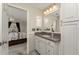 This bathroom features a granite vanity, built in cabinets, and view of the main bedroom at 446 Pendleton Ct, Venice, FL 34292