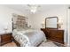 Cozy bedroom featuring a floral comforter, ceiling fan, and stylish wooden furniture at 446 Pendleton Ct, Venice, FL 34292