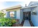 Welcoming front entrance featuring a well-manicured garden, blue shutters, and charming details at 446 Pendleton Ct, Venice, FL 34292