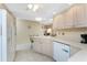 Bright kitchen with white appliances, a breakfast bar, and ample cabinet space for storage at 446 Pendleton Ct, Venice, FL 34292