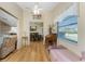 View of living and dining areas featuring lots of natural light and wood flooring at 446 Pendleton Ct, Venice, FL 34292