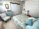 Bedroom view featuring bed, white closet, patterned wallpaper and accent furniture at 473 Sharks Pt, North Port, FL 34287