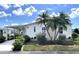 Charming single-story home with carport, lush landscaping, and decorative palm trees at 473 Sharks Pt, North Port, FL 34287