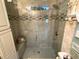 The remodeled shower includes a glass enclosure, decorative tile work, and a comfortable built-in bench at 473 Sharks Pt, North Port, FL 34287