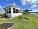 Bright sunroom with large windows offering beautiful view of the canal at 473 Sharks Pt, North Port, FL 34287