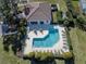 Aerial view of a community pool with a pool house, plenty of seating, and meticulously maintained landscaping at 5071 Winter Rose Way, Venice, FL 34293