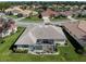 Aerial view of the home showcasing screened lanai and well-maintained landscaping at 5071 Winter Rose Way, Venice, FL 34293