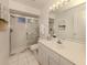 Well-lit bathroom featuring a glass-enclosed shower and clean, modern fixtures at 5071 Winter Rose Way, Venice, FL 34293