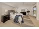 Well-lit main bedroom features neutral colors, ceiling fan, and access to the lanai at 5071 Winter Rose Way, Venice, FL 34293