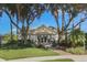 Charming community clubhouse with lush landscaping, inviting entrance, and beautiful architectural details under a clear sky at 5071 Winter Rose Way, Venice, FL 34293