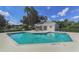 Community pool featuring a covered seating area with a table, and a tranquil space for residents to enjoy at 5071 Winter Rose Way, Venice, FL 34293