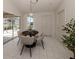 Bright dining room features modern chandelier, sliders to the lanai, and neutral colors at 5071 Winter Rose Way, Venice, FL 34293