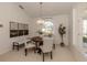 Dining area featuring modern lighting, comfortable seating, and a front-facing window at 5071 Winter Rose Way, Venice, FL 34293