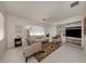 Bright living room featuring neutral colors, a ceiling fan, and built in shelving at 5071 Winter Rose Way, Venice, FL 34293