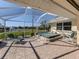 Relaxing screened patio with a hot tub, serene pond view and nice seating at 5071 Winter Rose Way, Venice, FL 34293