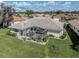 An expansive, screened in lanai overlooks the manicured lawn and garden at 5071 Winter Rose Way, Venice, FL 34293