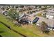 Aerial shot of a large backyard, mature tree, and a covered patio, set in a serene neighborhood at 537 Foxwood Blvd, Englewood, FL 34223