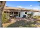 Backyard patio area offers covered seating, brick pavers, and well-maintained landscaping at 537 Foxwood Blvd, Englewood, FL 34223