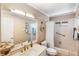 Cozy bathroom featuring vanity mirror, shower-tub combo, and decorative floral accents at 537 Foxwood Blvd, Englewood, FL 34223