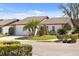 Charming home featuring a well-manicured lawn, palm trees, and a stone accent wall for added curb appeal at 537 Foxwood Blvd, Englewood, FL 34223