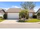 Exterior front view of the house with mature landscaping and a two-car garage at 537 Foxwood Blvd, Englewood, FL 34223