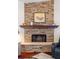 Stone fireplace featuring a wood mantle at 537 Foxwood Blvd, Englewood, FL 34223