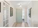 Inviting foyer with tile flooring, glass paneled doors, and neutral walls that create a bright and welcoming space at 537 Foxwood Blvd, Englewood, FL 34223