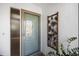 Front door featuring glass paneling, textured wall, and tropical-themed decor at 537 Foxwood Blvd, Englewood, FL 34223