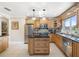 Traditional kitchen featuring wood cabinetry, stainless steel appliances, granite counters, and a functional center island at 537 Foxwood Blvd, Englewood, FL 34223