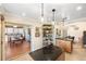 Open kitchen featuring an island, stylish pendant lights, and a seamless transition to the breakfast nook and living spaces at 537 Foxwood Blvd, Englewood, FL 34223