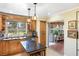 Spacious kitchen offering lots of natural light, granite counters, and backyard views from the window above the sink at 537 Foxwood Blvd, Englewood, FL 34223