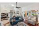 Cozy living area featuring a blue sofa, glass coffee table, and access to the backyard at 537 Foxwood Blvd, Englewood, FL 34223