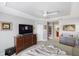 Relaxing main bedroom with a plush throw blanket, a TV atop a dresser, and a ceiling fan at 537 Foxwood Blvd, Englewood, FL 34223