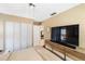 Bright main bedroom featuring a large closet and a media center with a mounted TV at 537 Foxwood Blvd, Englewood, FL 34223