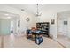 Well-lit home office with a desk, bookcase, and tiled floors at 537 Foxwood Blvd, Englewood, FL 34223