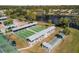 Aerial view of community shuffleboard and bocce courts, with seating near a serene lake, and the community pool nearby at 537 Foxwood Blvd, Englewood, FL 34223