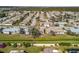 A street view of single-story homes, showcasing their manicured lawns, complemented by the lush greenery of a well-planned community at 537 Foxwood Blvd, Englewood, FL 34223