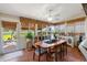 Sunroom with walls of windows, a ceiling fan, and ample seating for dining or relaxing at 537 Foxwood Blvd, Englewood, FL 34223