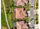 Overhead view of the homes showcasing tile roofs, screened lanais, and well-manicured lawns at 5371 White Ibis Dr, North Port, FL 34287