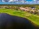 Overhead view of community featuring golf course, lake, and well-maintained landscaping at 5371 White Ibis Dr, North Port, FL 34287